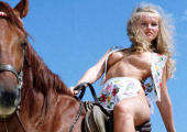 blonde girl riding showing her tits